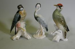 A Karl Ens porcelain figure of a woodpecker, marked 7527, 25cm high, a hawk 7514 and a stork 7800