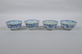Four Chinese Ming style blue and white porcelain tea bowls decorated with flowers, carp, figures and