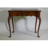 A George style walnut card table with shaped top and frieze, fitted with a single drawer, raised