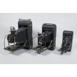 Three early C20th medium and large format cameras including a Kodak No.3A Autographic, a Houghton