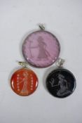 Three Persian white metal pendants set with engraved figural intaglio stones