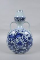 A blue and white porcelain two handled garlic head shaped flask decoration with carp in a lotus