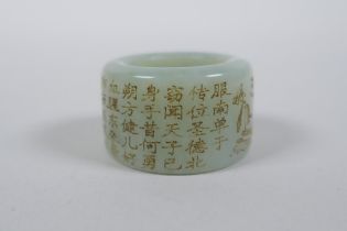 A Chinese celadon jade archer's thumb ring with engraved character inscription decoration, 3cm