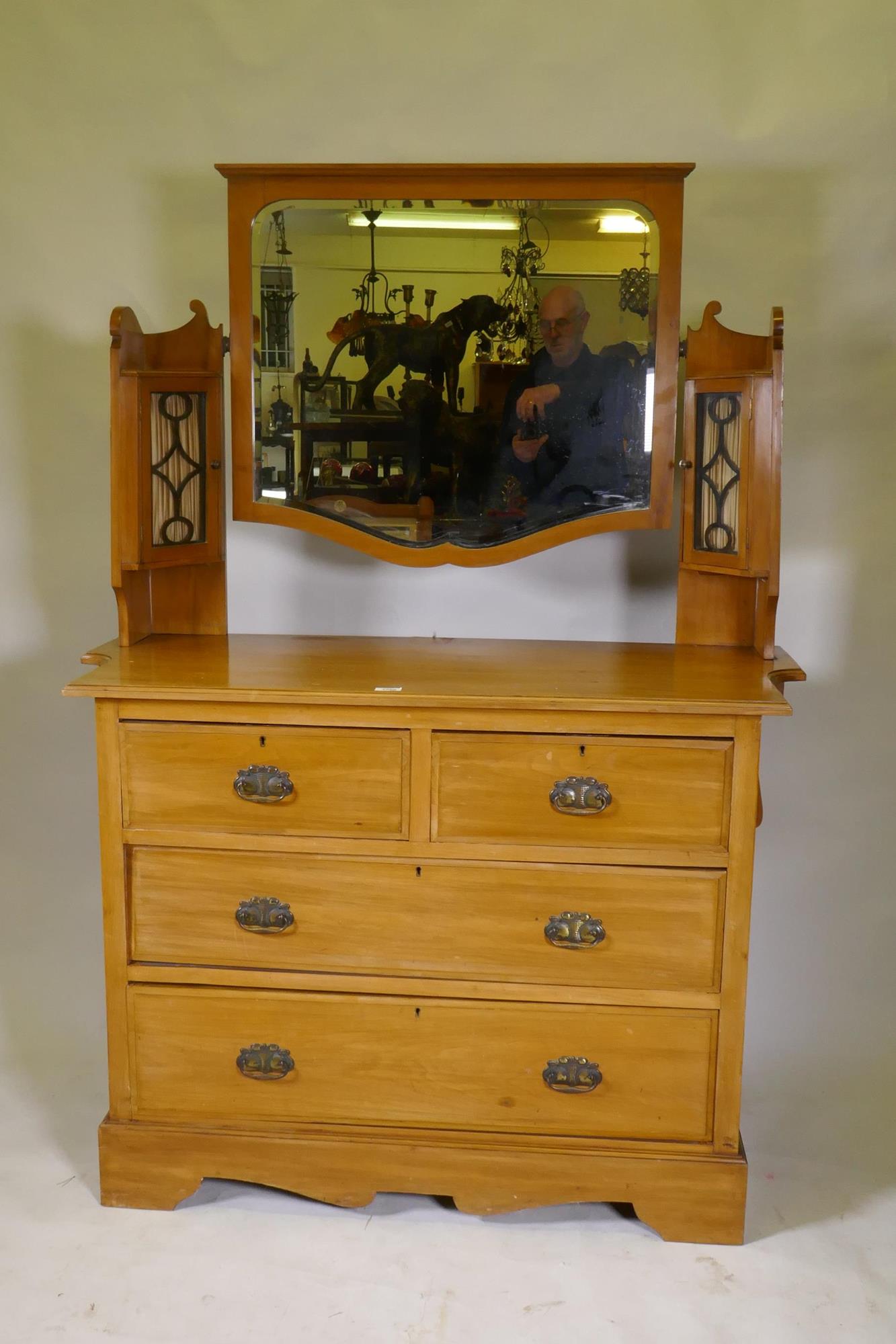 A Victorian satinwood dressing table, the upper section with mirror flanked by glazed cabinets,