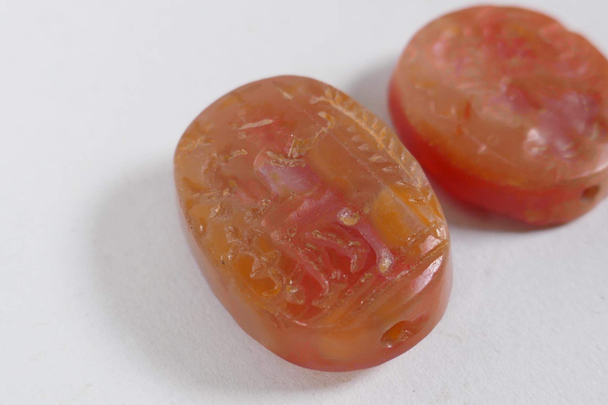 Two Persian amber agate intaglio beads with figural decoration, 2 x 2.5cm - Image 2 of 3