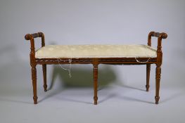 A walnut window seat with carved decoration raised on fluted tapering supports, 116 x 43 x 60cm