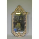 A carved and painted wall mirror, AF losses, 136cm high
