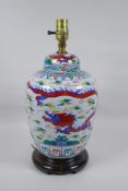 A Chinese Wucai porcelain jar and cover with dragon decoration, converted to a lamp, 41cm high