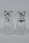 A pair of silver plated and glass salt and pepper shakers in the form of cats, 12cm high