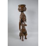 An African carved hardwood Senufo maternity figure, 63cm high