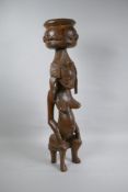 An African carved hardwood Senufo maternity figure, 63cm high