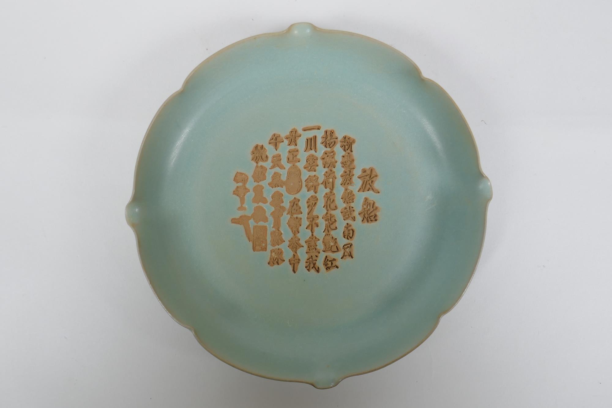 A Chinese Ru ware style porcelain dish with lobed rim and chased character inscription, 2