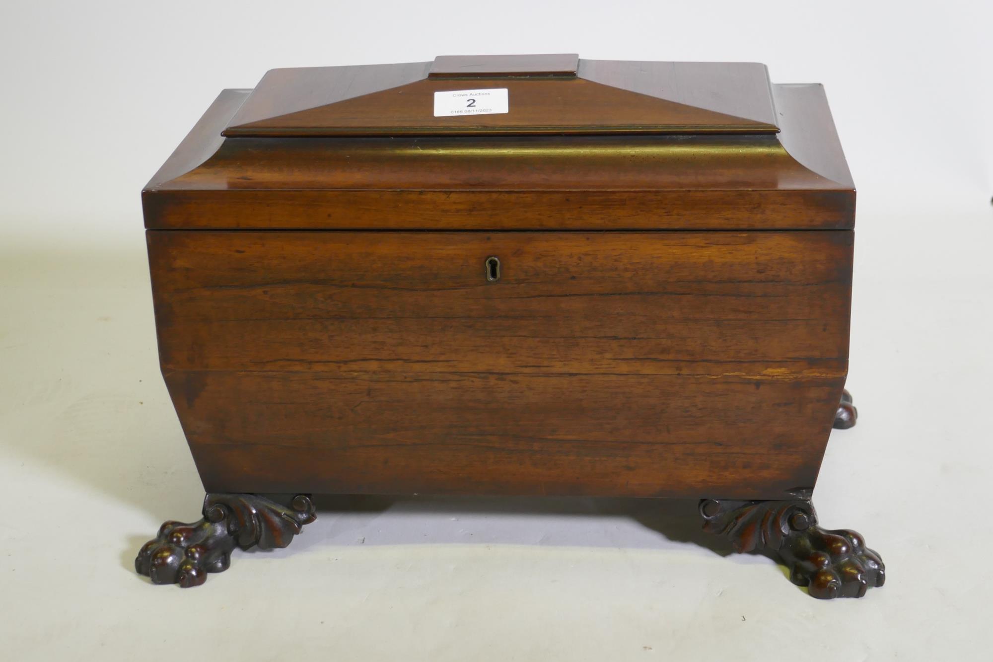A good Regency mahogany two division tea caddy of sarcophagus shape, the interior with two lidded