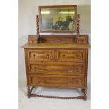 An early C20th oak Jacobean style dressing table, with swing mirror supported by barley twist