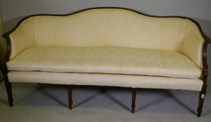 A Hepplewhite style humpback settee with scroll arms, raised on tapering supports, 200cm wide
