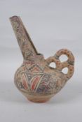 An Islamic terracotta wine jug with painted decoration, 22cm high
