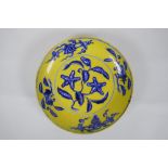 A Chinese imperial yellow ground porcelain dish with blue and white floral decoration, Zhengde 4