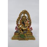 A Tibetan painted and gilt bronze figure of the deity Jambhala, 24cm high