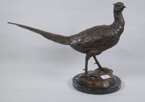 A bronze figure of a pheasant, mounted on a marble base, unsigned, 33cm high