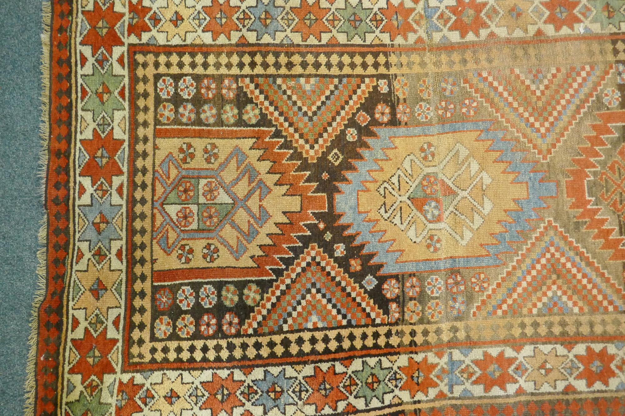 A multi colour ground Kurdish Kazak wool runner with a geometric medallion design on a brown - Image 3 of 6