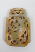 A Chinese carved and pierced jade scroll weight decorated with a buffalo and dragon, 5 x 8.5cm