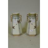 A pair of porcelain vases with gilt highlights and raised decoration depicting flying geese, 31cm