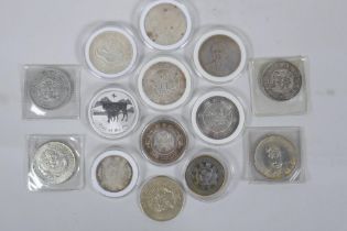 A quantity of Chinese facsimile (replica) white metal coinage, many coins in collector's cases