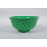 A Chinese apple green glazed porcelain rice bowl with raised dragon decoration, Zengde 6 character