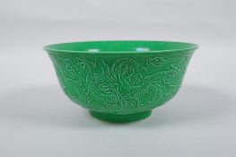 A Chinese apple green glazed porcelain rice bowl with raised dragon decoration, Zengde 6 character