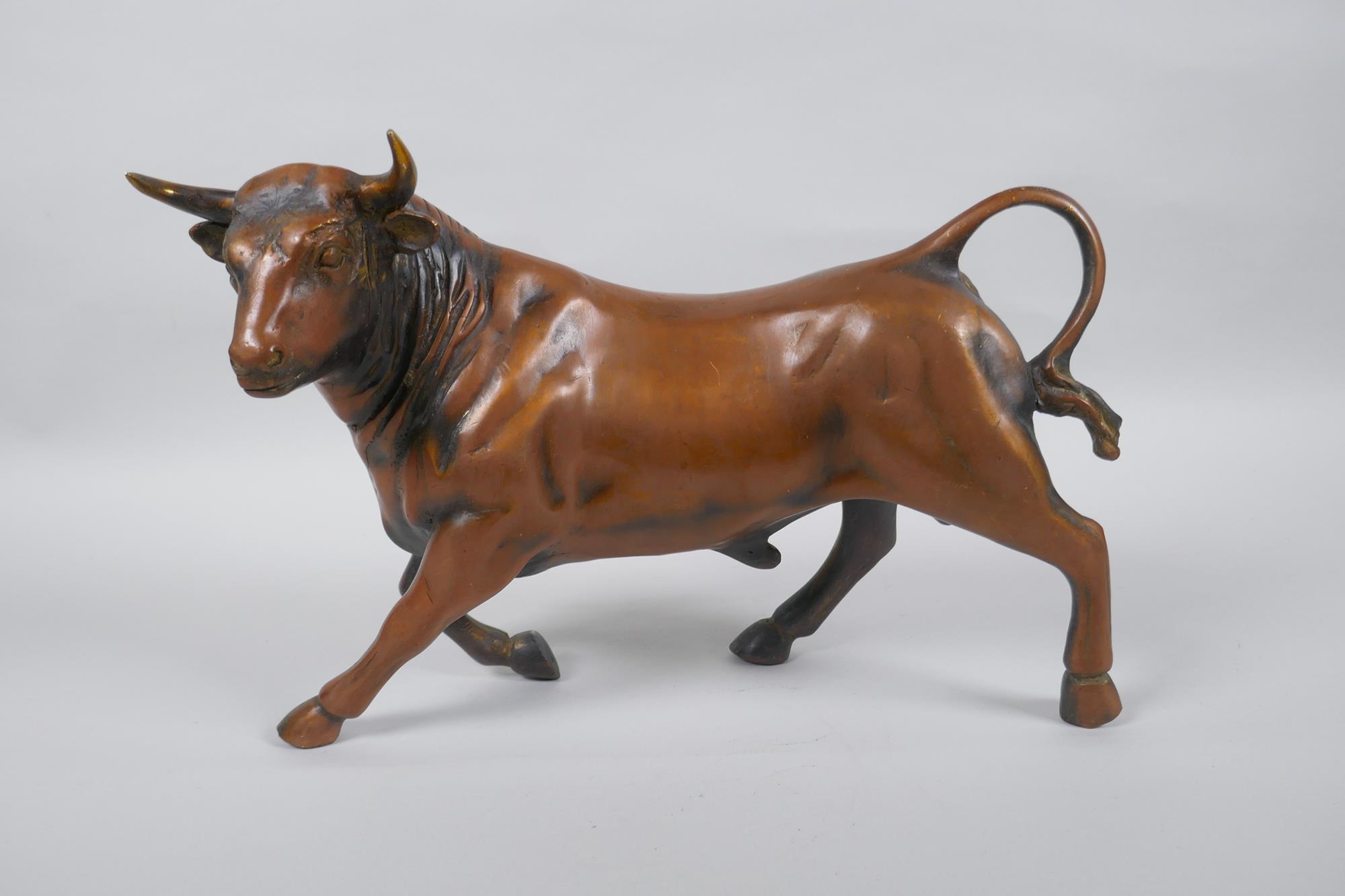 A filled coppered metall bull, 30cm long