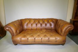 A Tetrad Oskar deep buttoned tan leather sofa, 200cm wide