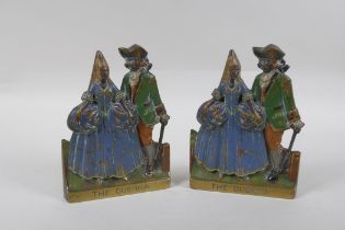 A pair of antique cold painted bronze and brass book ends themed after the opera The Duenna, 16cm