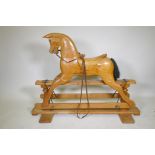 A vintage pine rocking horse with carved saddle, 107cm high, 144cm long