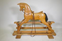 A vintage pine rocking horse with carved saddle, 107cm high, 144cm long