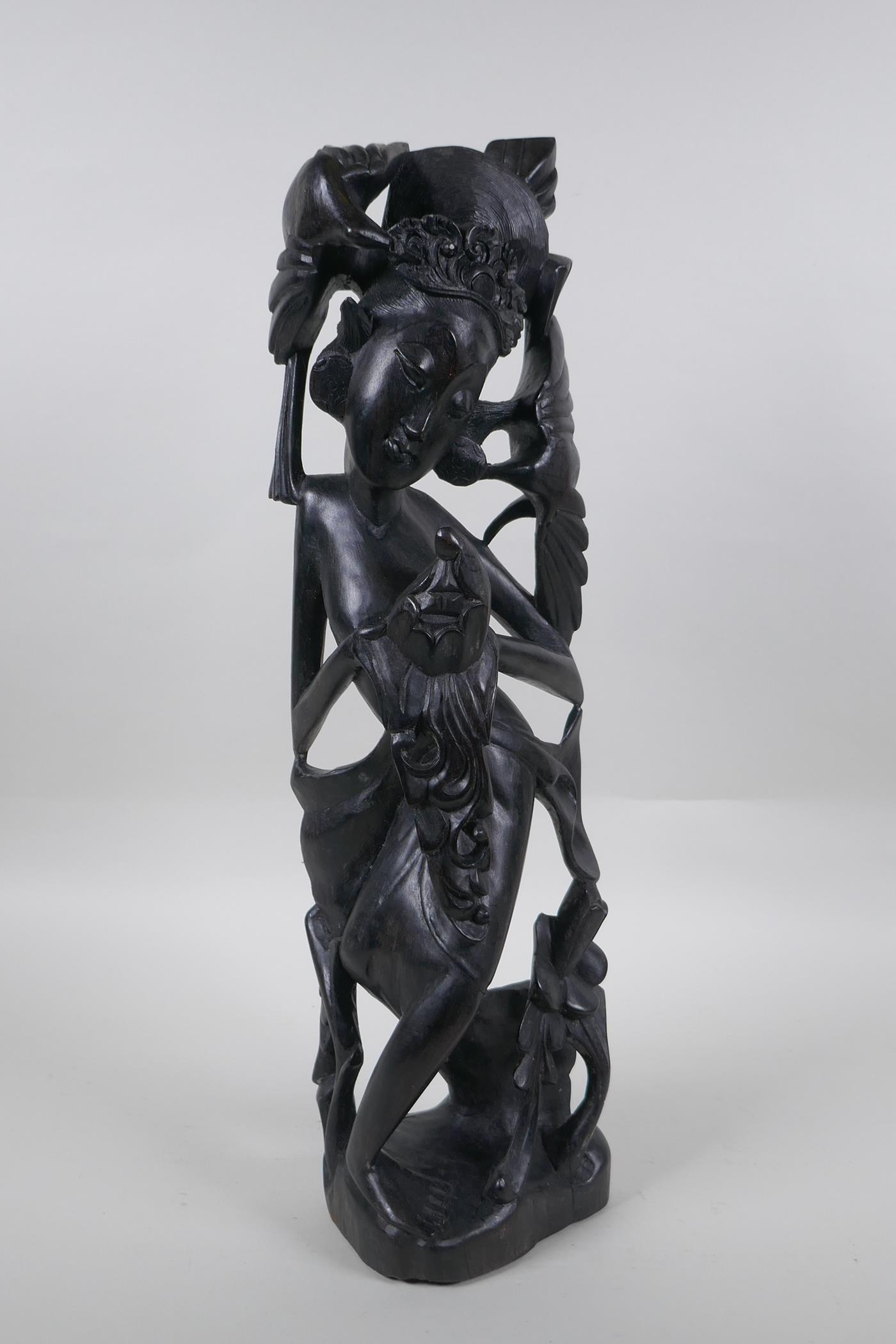 A Balinese carved hardwood figure of a dancer, 45cm high