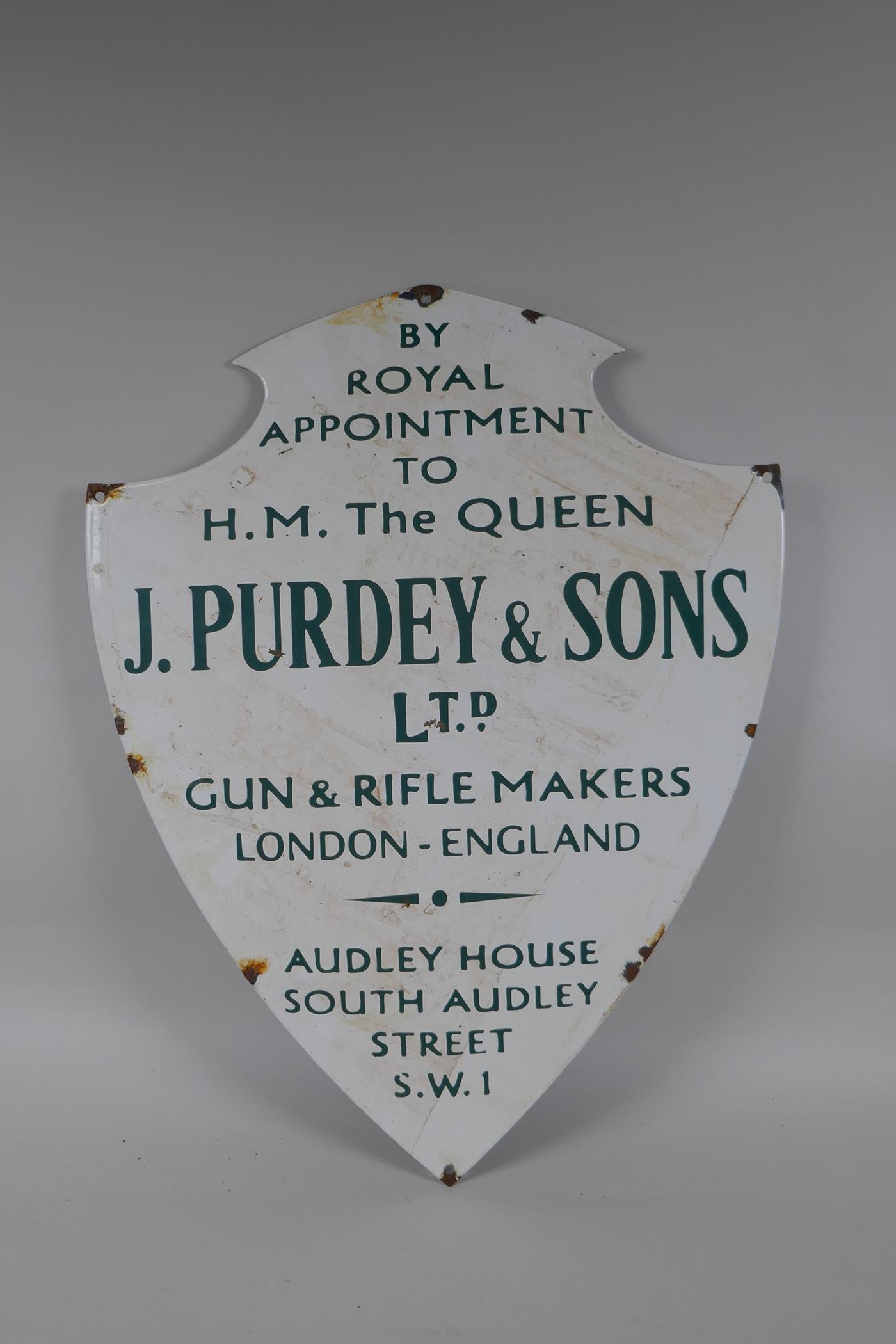 A vintage style James Purdey & Sons Ltd shield shaped enamel sign, 39 x 51cm