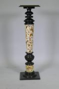 A C19th column, with ebonised wood and inset Zsolnay Pecs style raised decoration 106cm high, 30 x