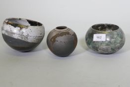 A studio pottery multi glazed pot, signed to base, 10cm high, and two bowls, drip glazed, unsigned