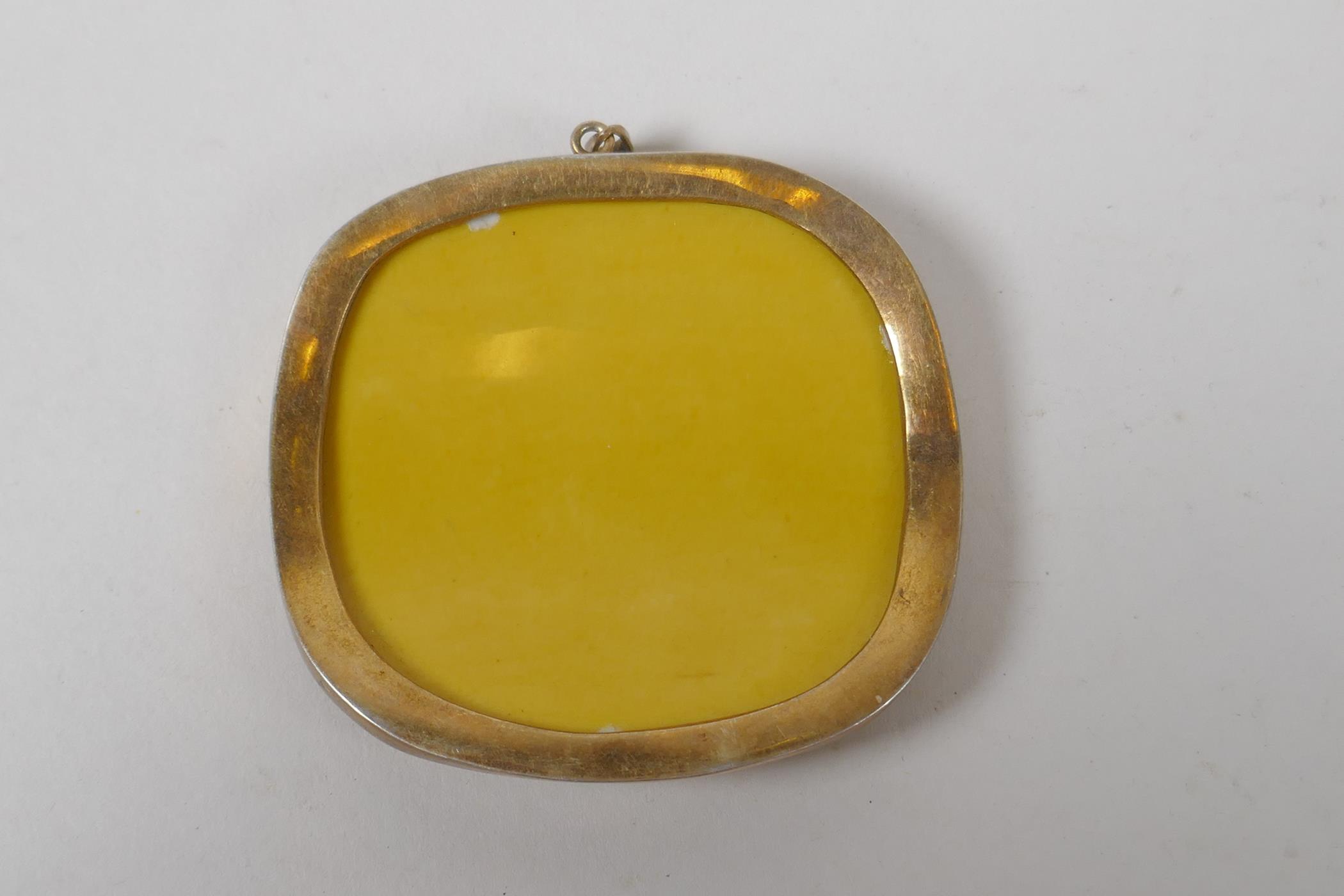 A Chinese imperial yellow porcelain shard in a yellow metal pendant mount, 6cm x 5.5cm - Image 2 of 2