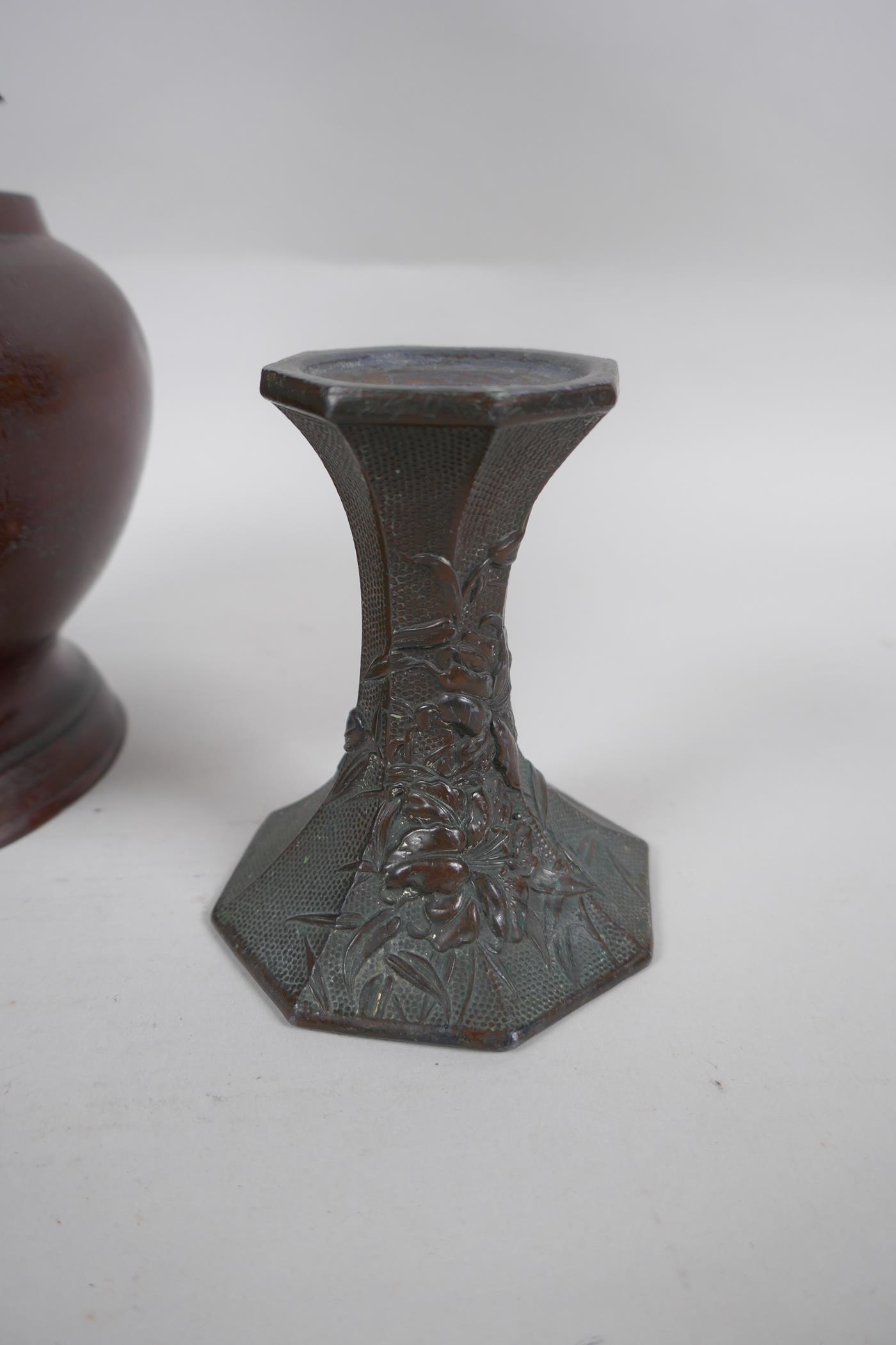 A pair of early C20th Japanese bronze candlesticks of hexagonal waisted form, with raised floral - Image 3 of 6