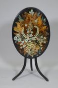 A Victorian ebonised tilt top occasional table with painted and stencilled fern decorated top,