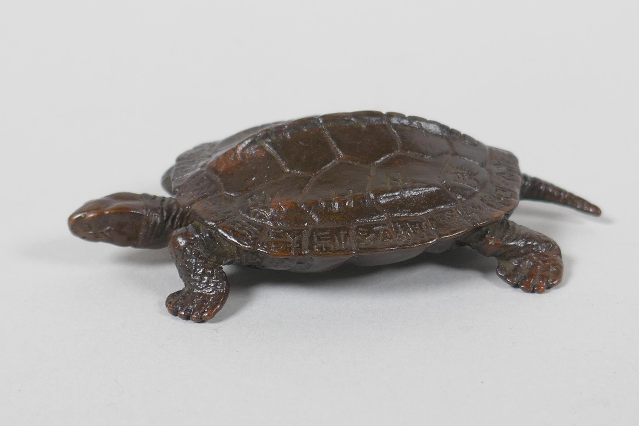 A Japanese style bronze okimono tortoise, 7cm long