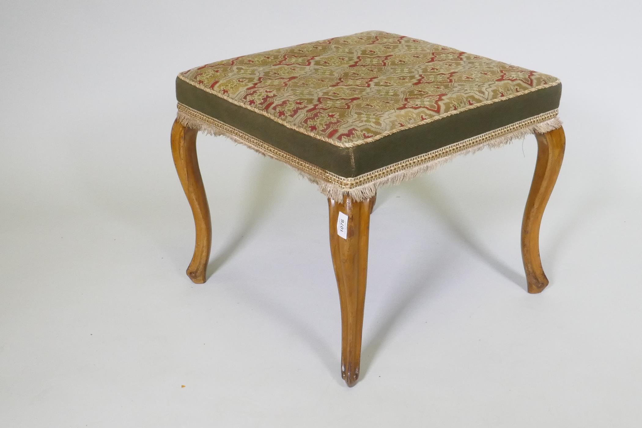 A Victorian walnut stool with tapestry cover, raised on cabriole supports, 53 x 53 x 46cm