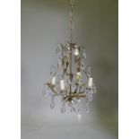 A French style silver leafed metal four branch chandelier with lustre drops, 45cm high, 105cm long
