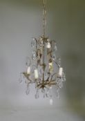 A French style silver leafed metal four branch chandelier with lustre drops, 45cm high, 105cm long