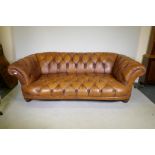 A Tetrad Oskar deep button tan leather sofa, 230cm wide