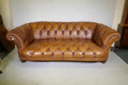 A Tetrad Oskar deep button tan leather sofa, 230cm wide