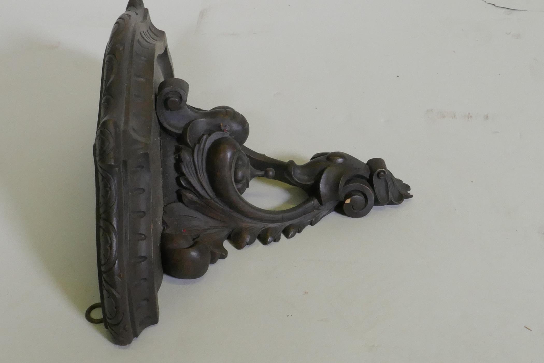 A C19th carved walnut wall bracket, 40cm wide, 29cm high - Image 3 of 3