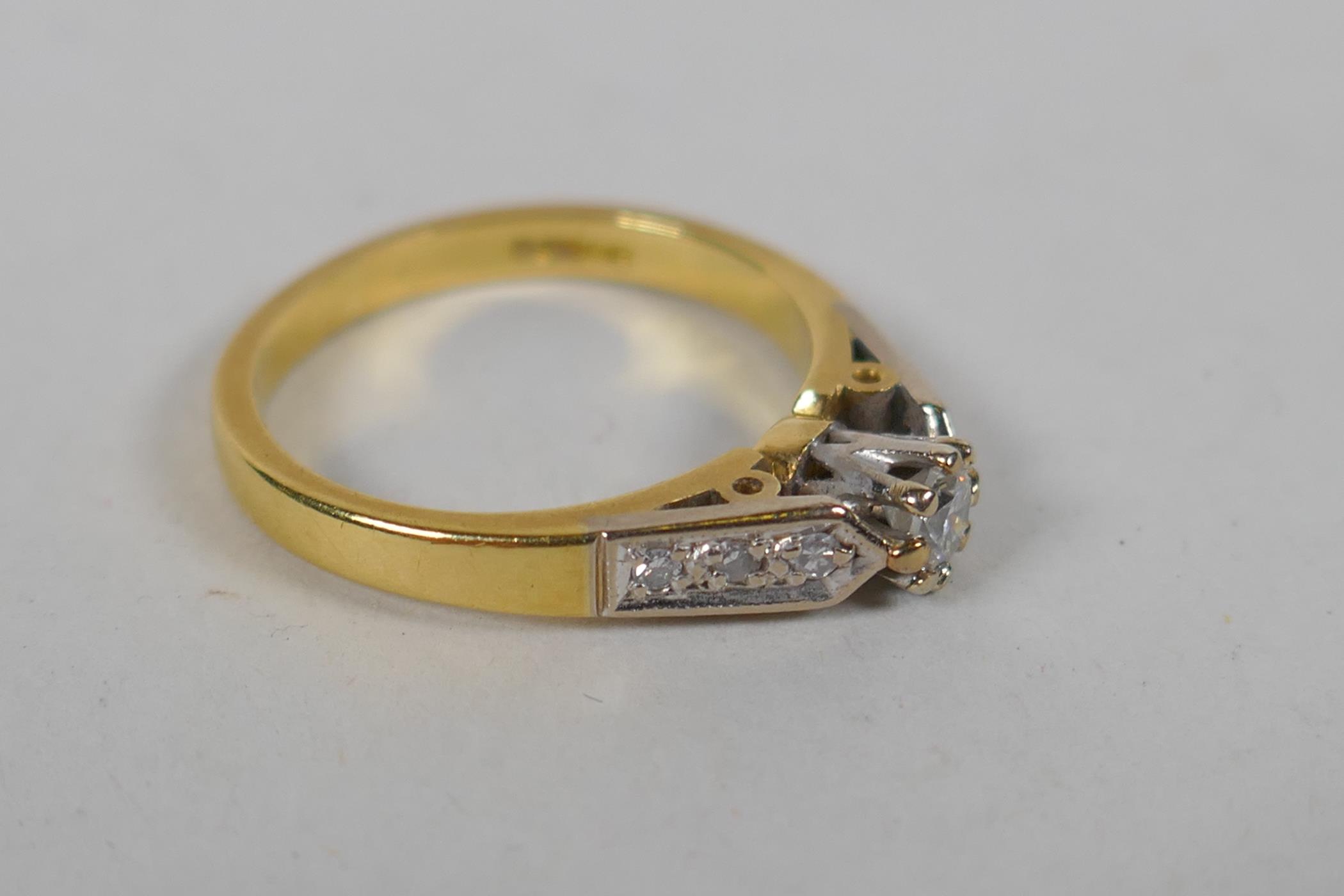 An 18ct yellow gold and diamond ring, with a central set diamond and three diamonds set to each - Image 2 of 5