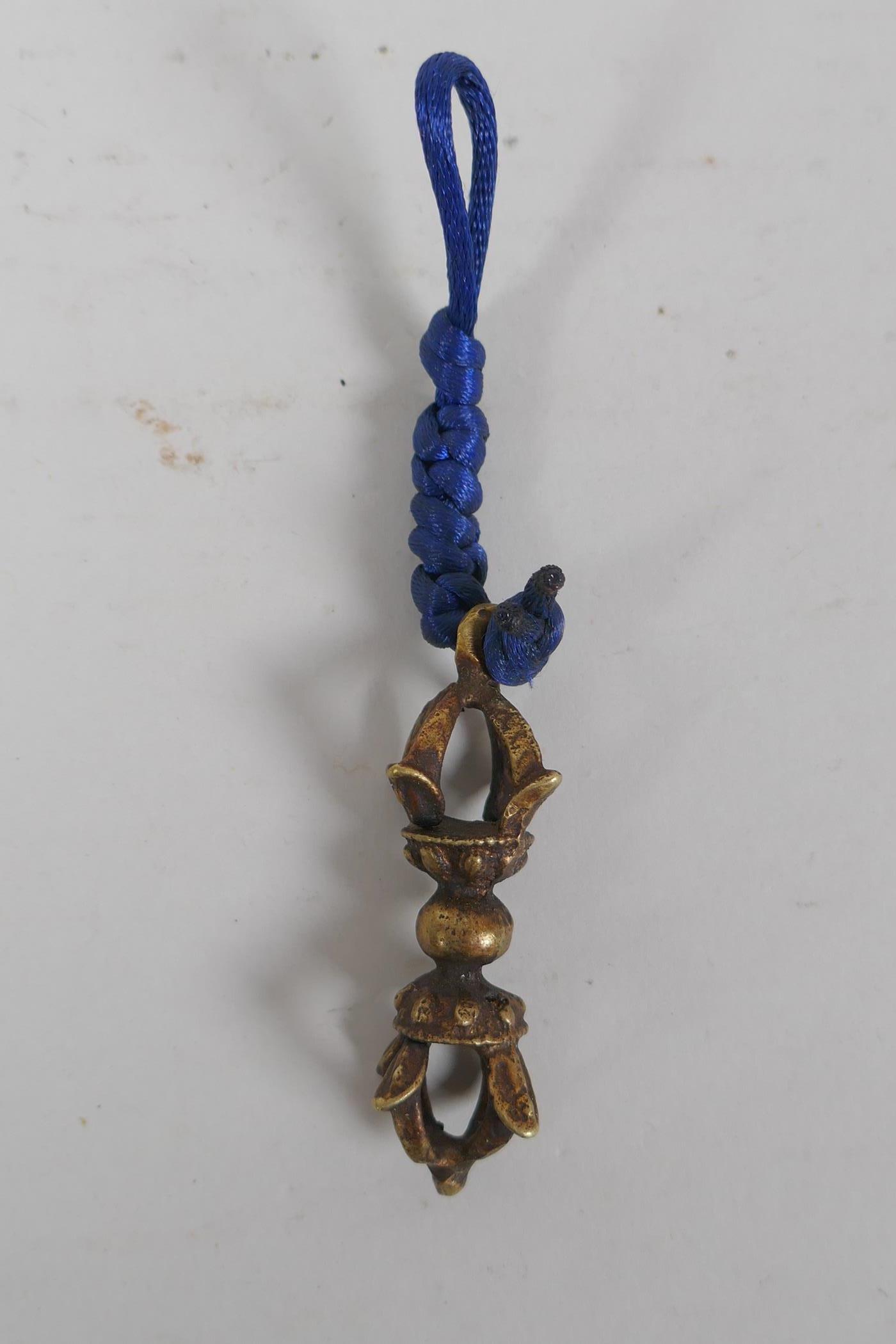 A small Tibetan bronze double vajra pendant and a similar sized vajra pendant, 6 x 6cm - Image 3 of 3